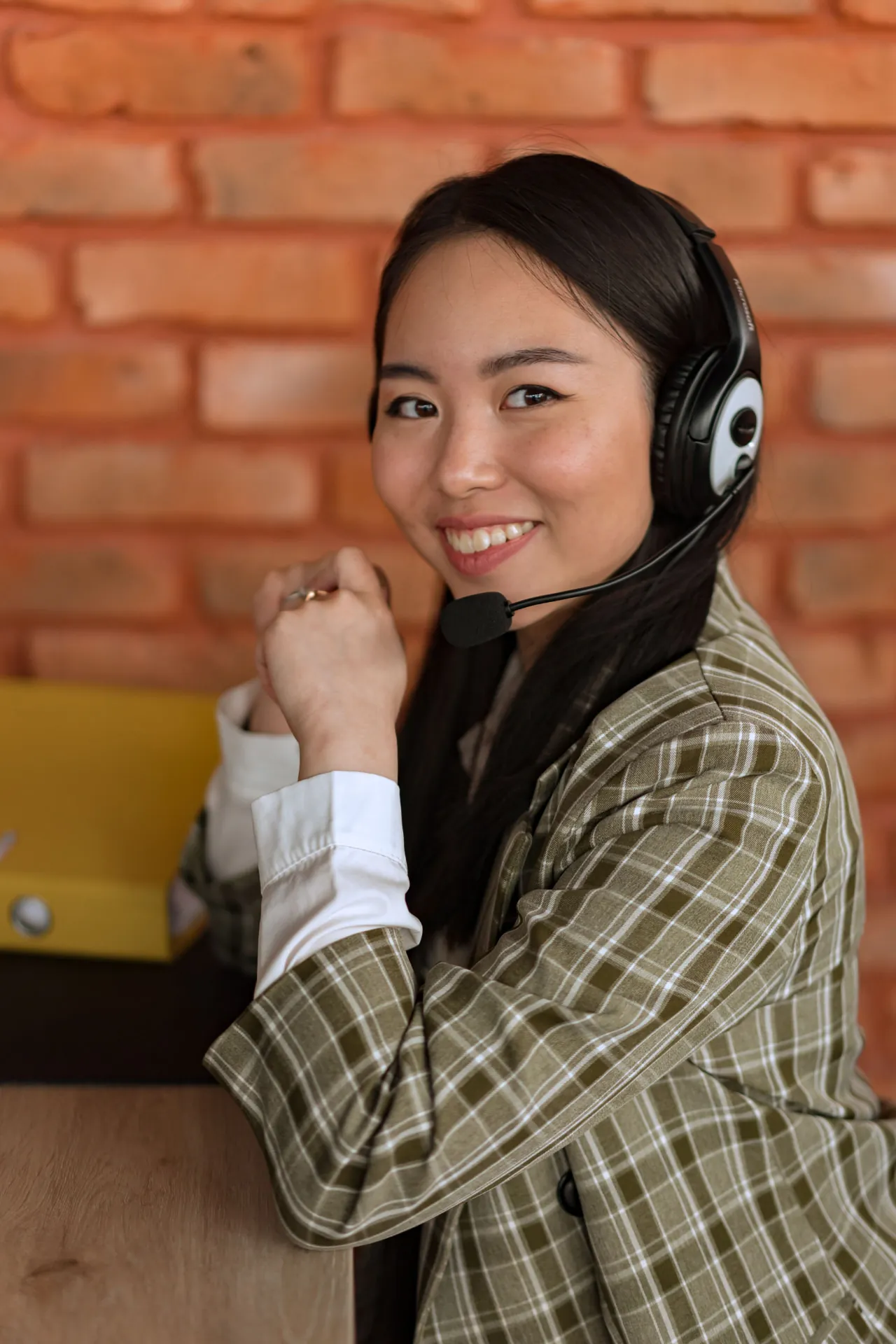 Smiling Filipino virtual assistant wearing a headset, ready to help